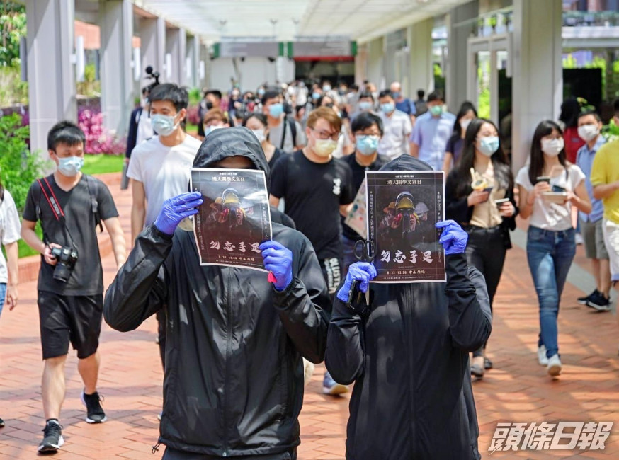「守護港大聯署小組」成員在港大派發文宣。