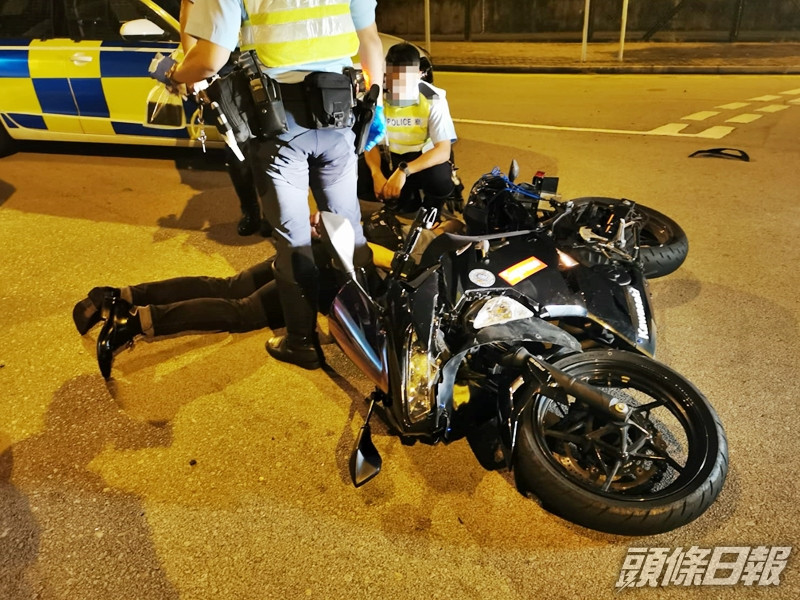 涉案男子駕電單車掉頭時,疑失控硬撼警車,致人仰車翻受傷倒地,警方上前將其拘捕。警方圖片