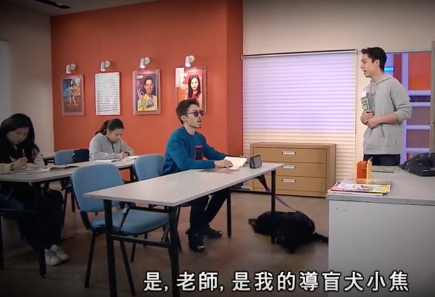 《愛.回家》其中一幕有一位假扮弱視並帶同導盲犬前來的男同學。影片截圖